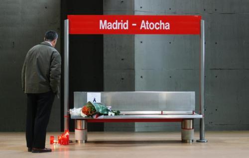 A man pays his respects at memorial site at Madrid's Atocha station.